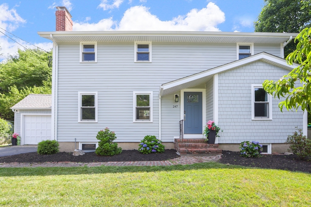 247 Greendale Avenue Needham, MA 02494 - Photo 25 of 33 a front view of a house with a yard and potted plants
