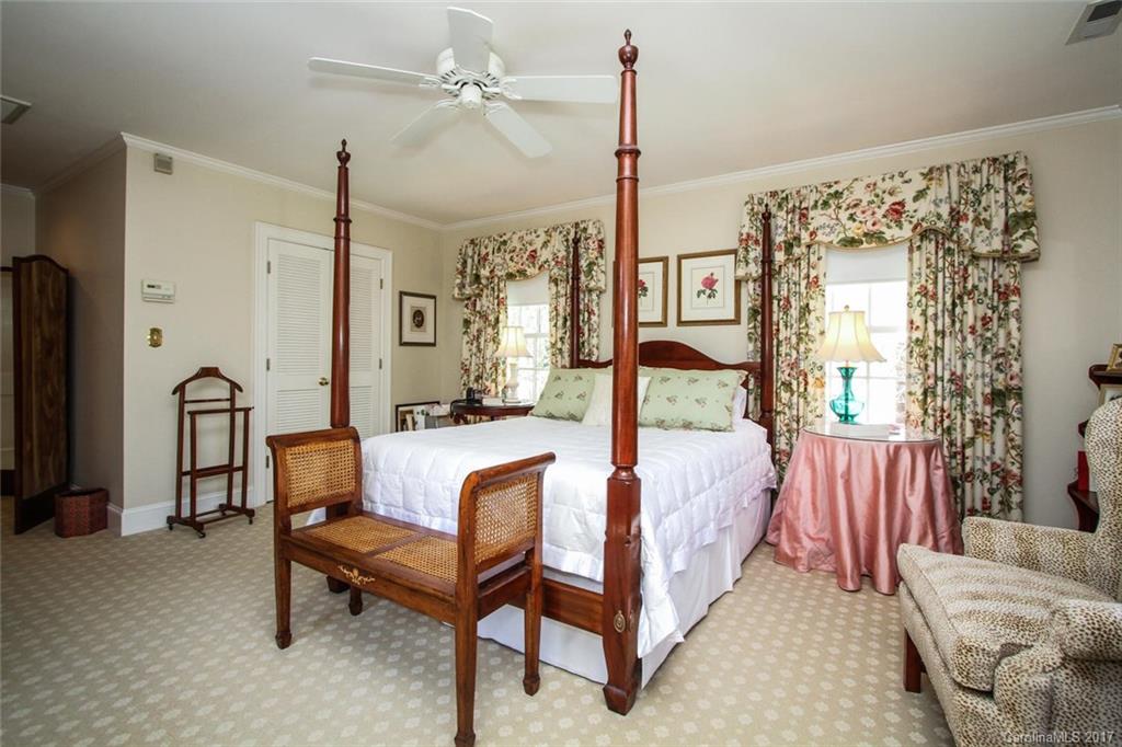 1245 Providence Road Charlotte, NC 28207 - Photo 15 of 24 a bed room with a bed and a chandelier