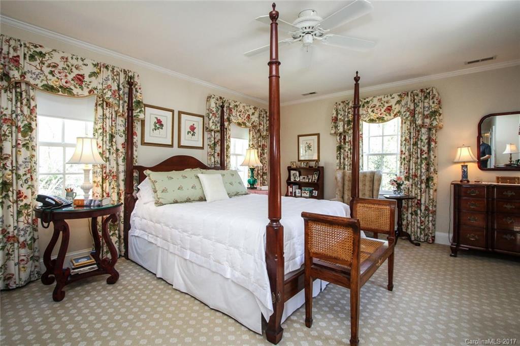 1245 Providence Road Charlotte, NC 28207 - Photo 16 of 24 a bedroom with a bed a table and chair