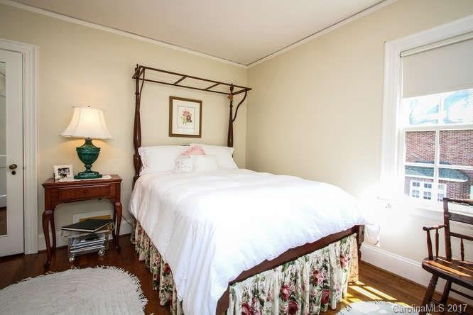 1245 Providence Road Charlotte, NC 28207 - Photo 20 of 24 a bedroom with a bed table chair and a window