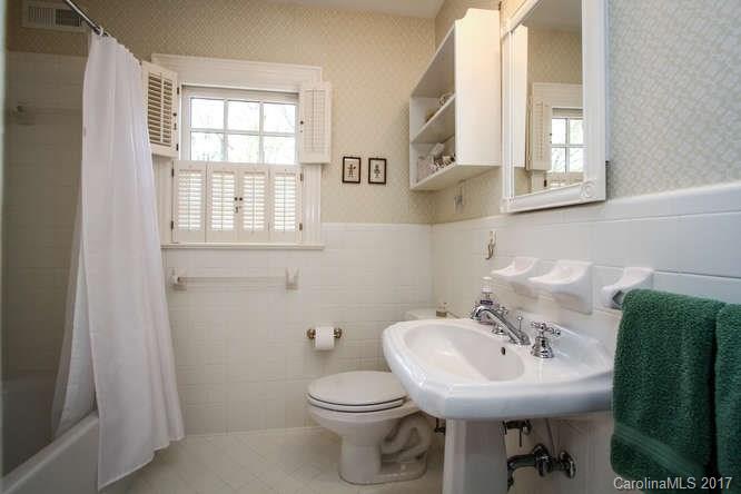 1245 Providence Road Charlotte, NC 28207 - Photo 22 of 24 a bathroom with a sink toilet and a mirror