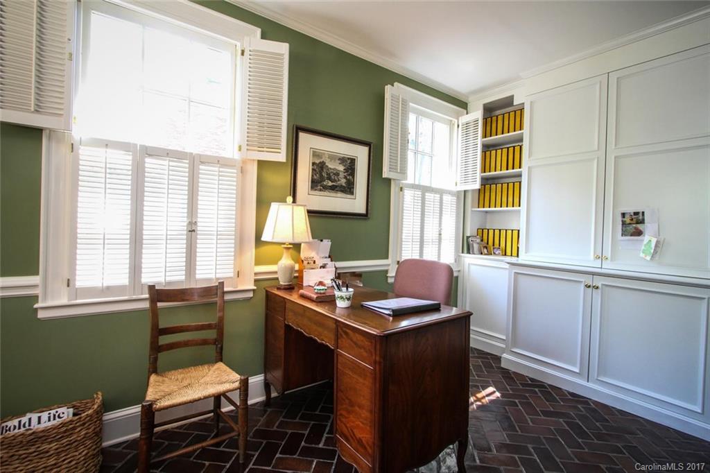 1245 Providence Road Charlotte, NC 28207 - Photo 8 of 24 a room that has a chair and a table in it