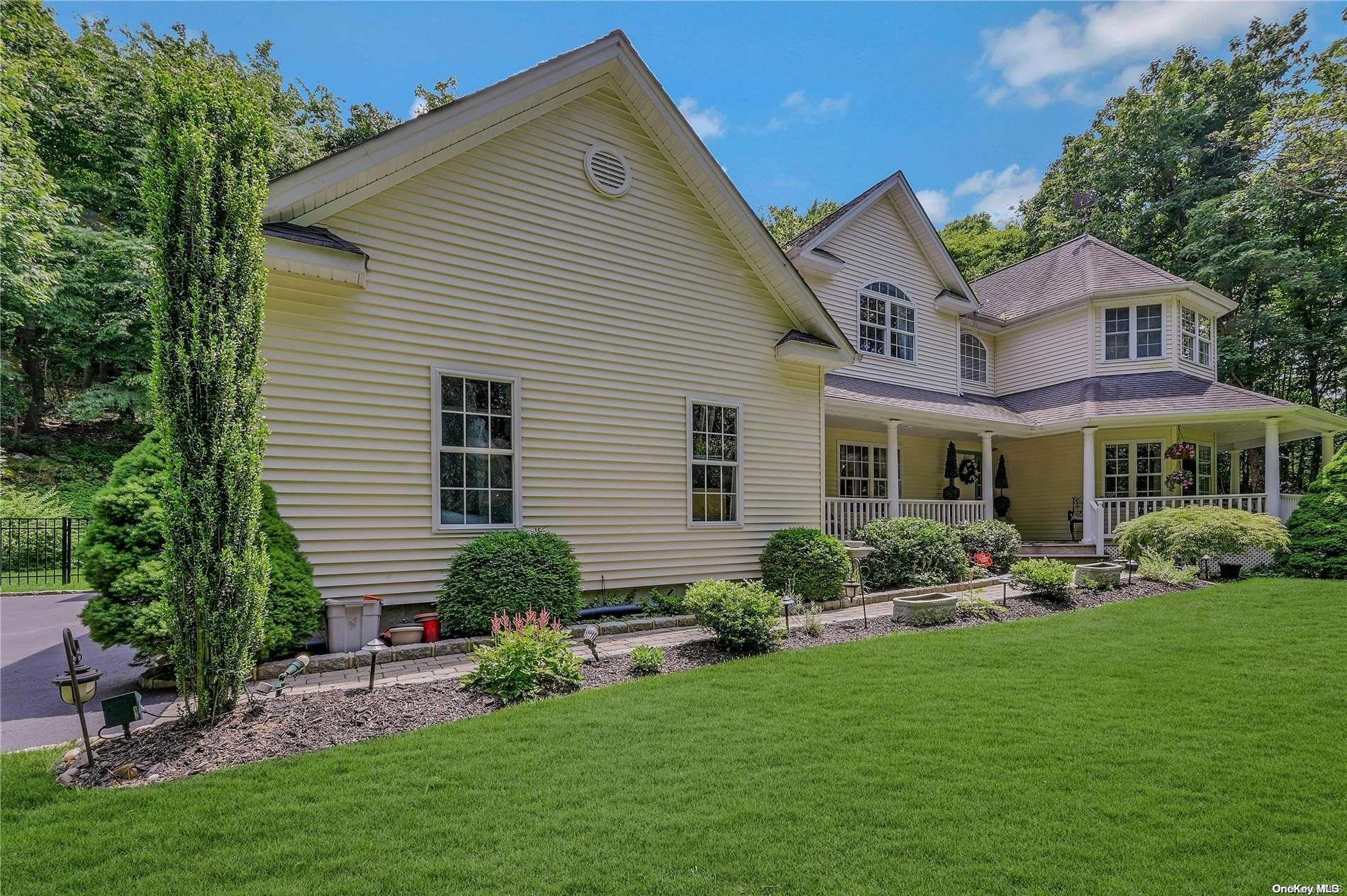 a front view of a house with a garden and plants