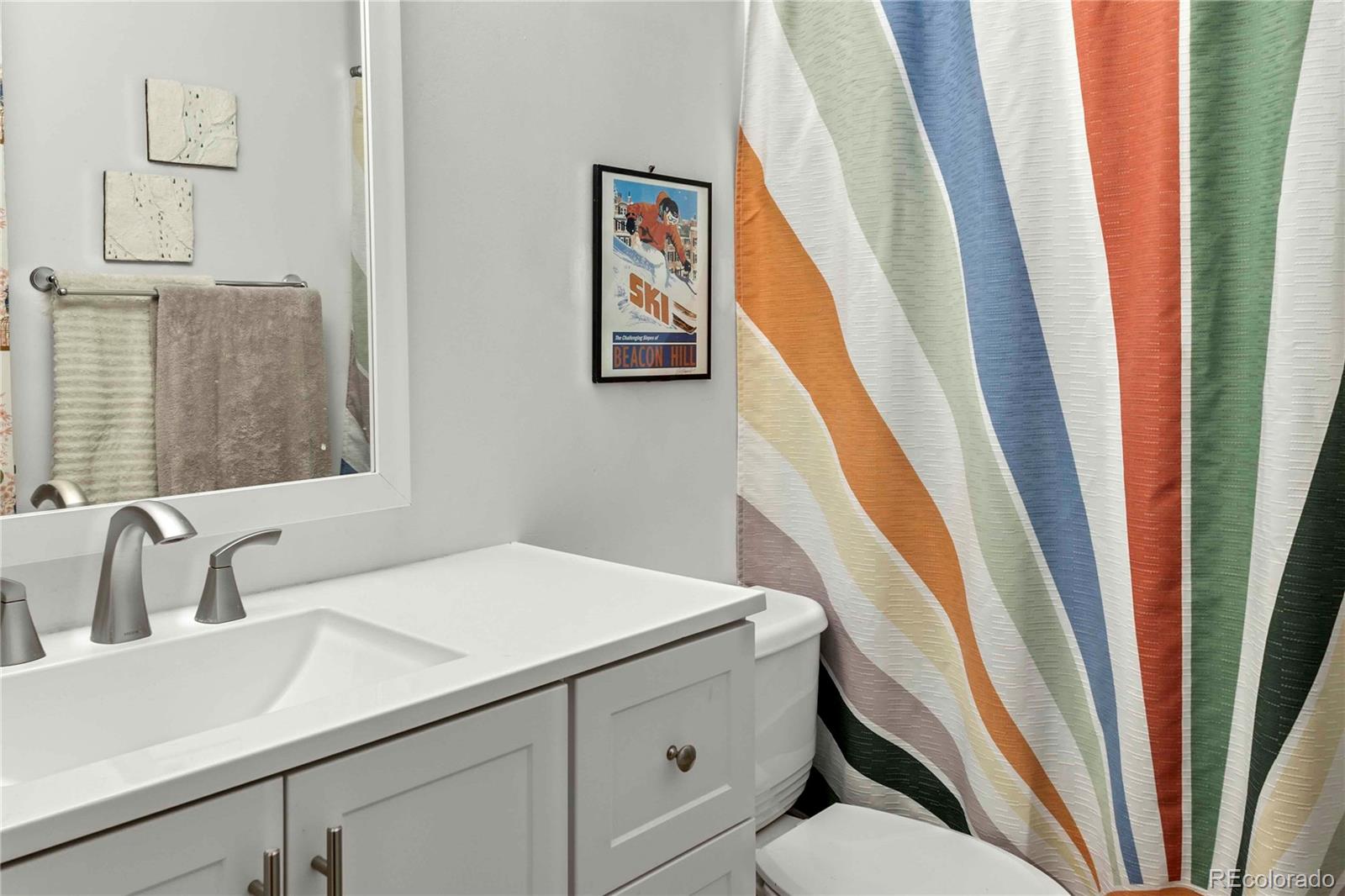 3358 Pontiac Street Denver, CO 80207 - Photo 11 of 26 a bathroom with a sink and a mirror