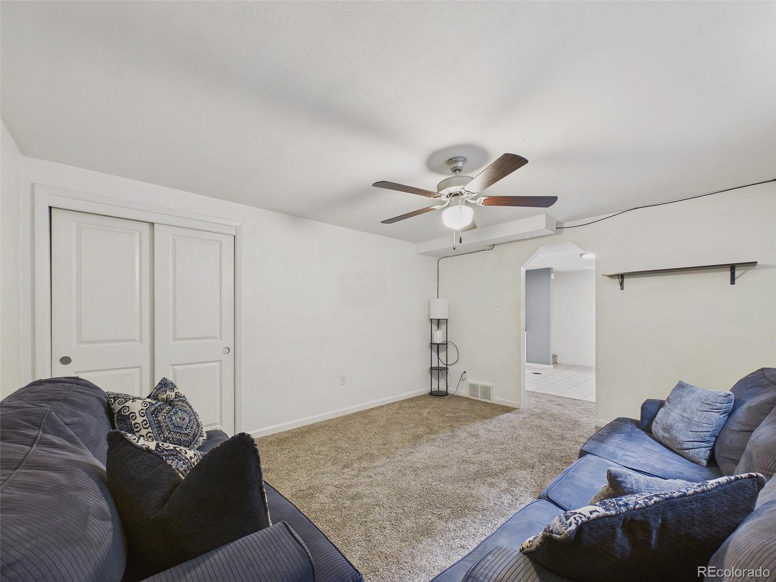 3358 Pontiac Street Denver, CO 80207 - Photo 15 of 26 a living room with furniture and a rug
