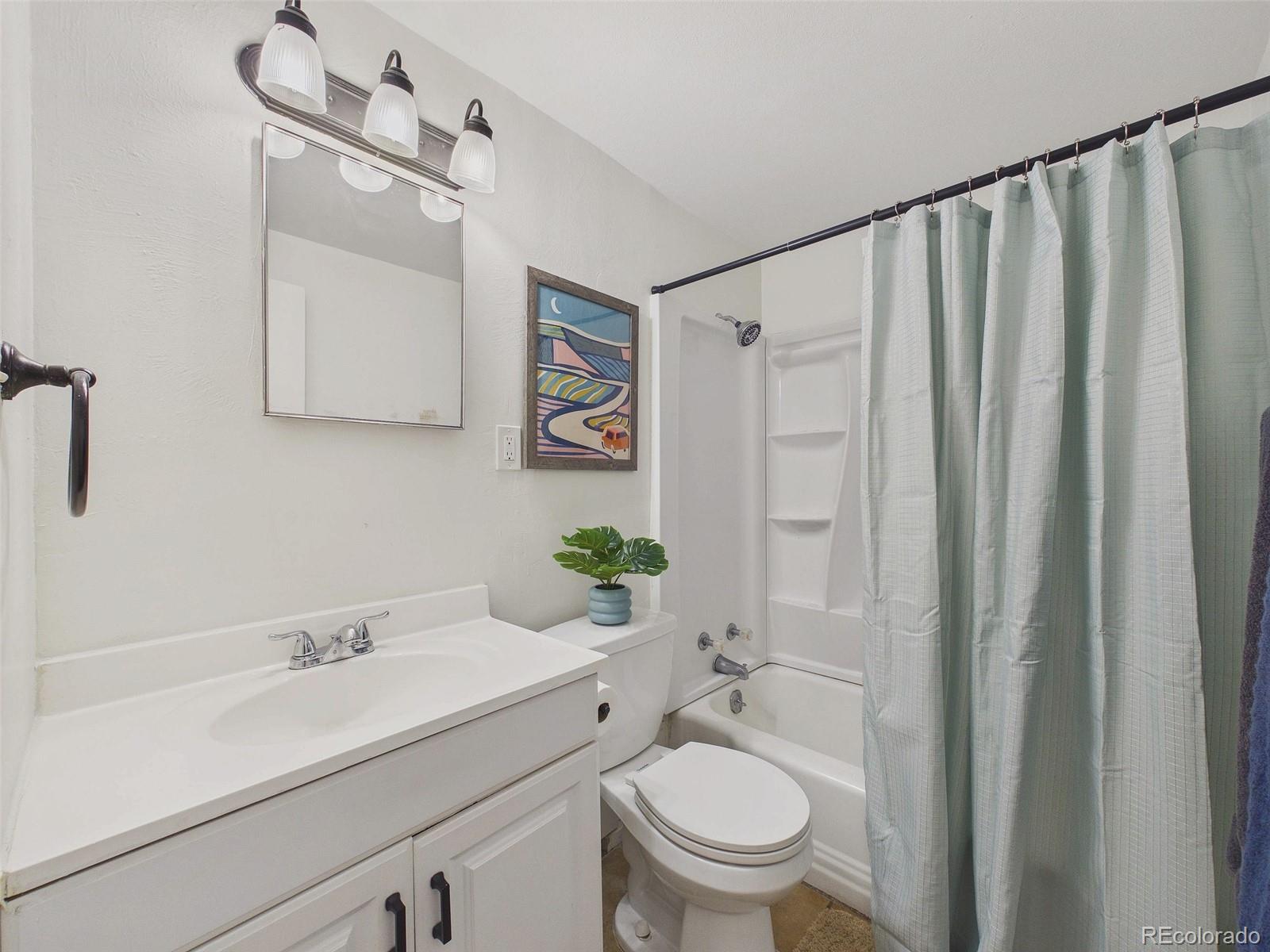 3358 Pontiac Street Denver, CO 80207 - Photo 20 of 26 a bathroom with a sink a toilet and shower