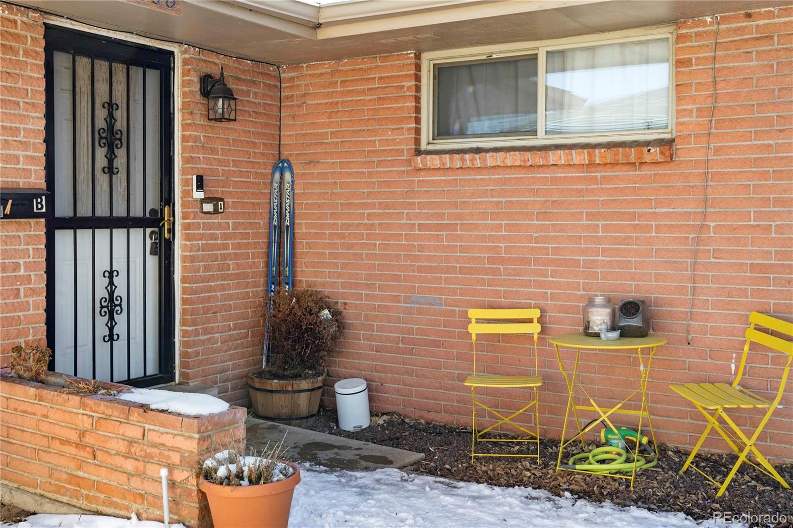 3358 Pontiac Street Denver, CO 80207 - Photo 22 of 26 a view of a brick house with potted plants