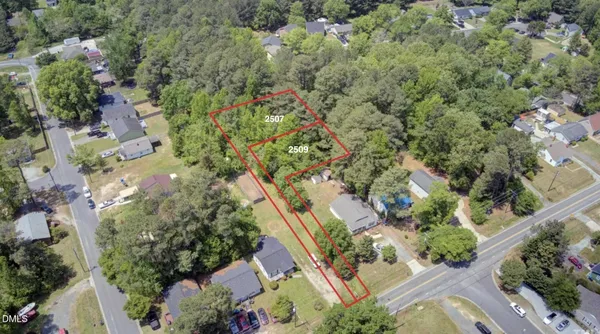 an aerial view of a house with a yard and garden