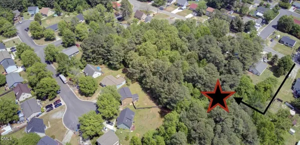 an aerial view of a house with a yard and outdoor seating