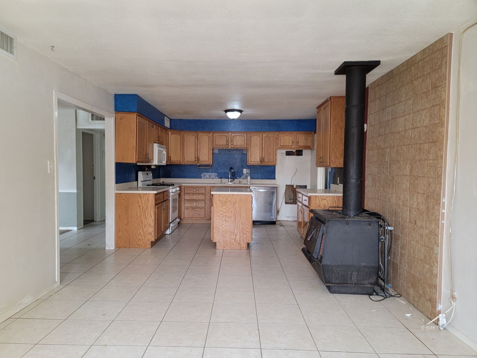 345 South Gordon Street Ridgecrest, CA 93555 - Photo 9 of 22 a kitchen with stainless steel appliances a refrigerator and a stove top oven
