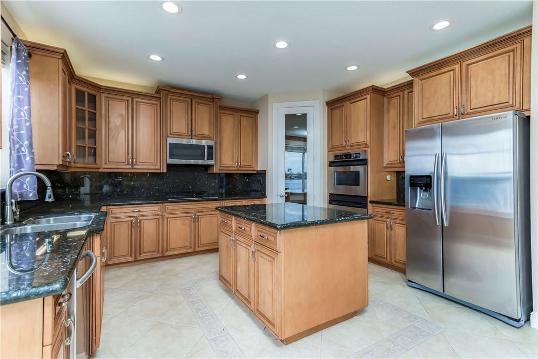 4185 Southwest 186th Way Miramar, FL 33029 - Photo 24 of 92 a kitchen with stainless steel appliances granite countertop a refrigerator and a stove top oven