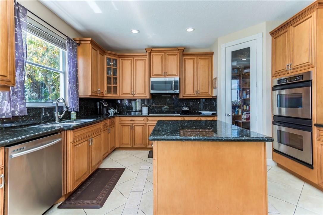 4185 Southwest 186th Way Miramar, FL 33029 - Photo 26 of 92 a kitchen with stainless steel appliances granite countertop a stove a sink and a microwave