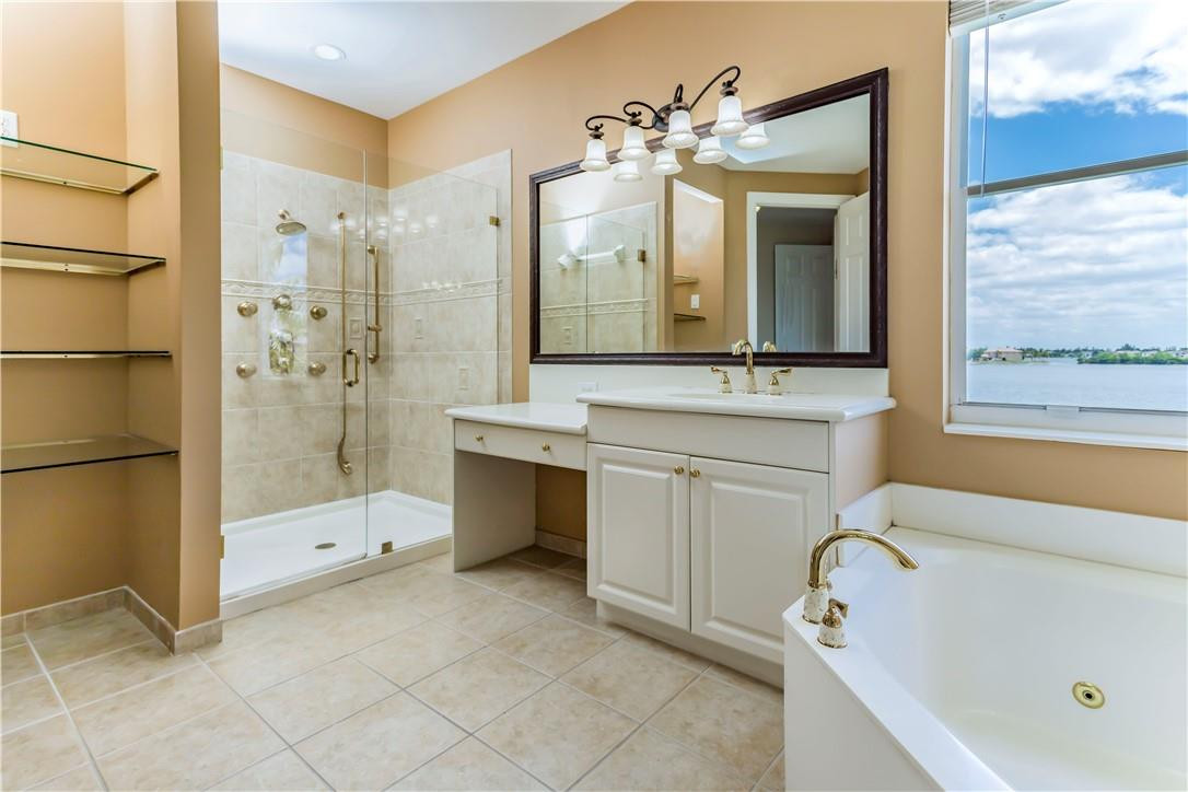 4185 Southwest 186th Way Miramar, FL 33029 - Photo 40 of 92 a bathroom with a tub sink and mirror