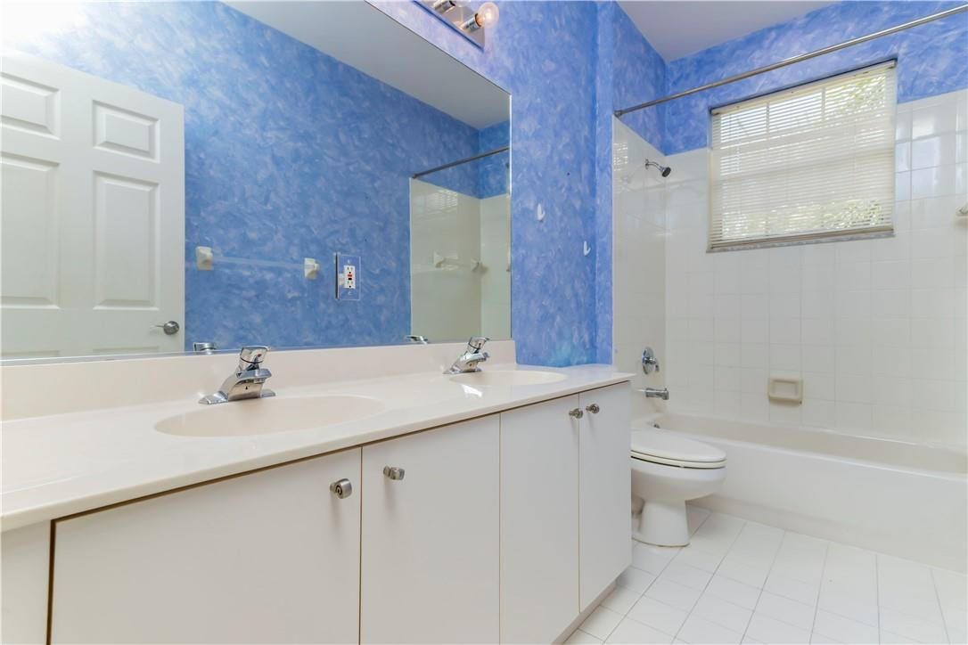 4185 Southwest 186th Way Miramar, FL 33029 - Photo 43 of 92 a bathroom with a double vanity sink toilet and shower