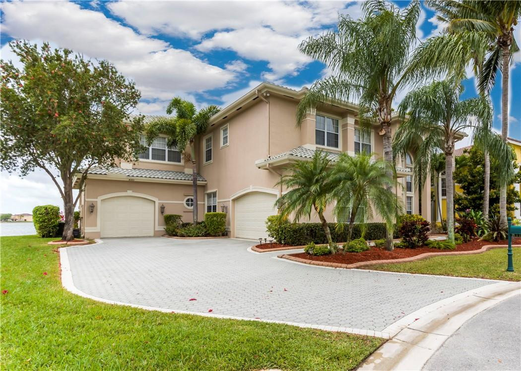 4185 Southwest 186th Way Miramar, FL 33029 - Photo 67 of 92 a view of a white house with a small yard plants and palm trees