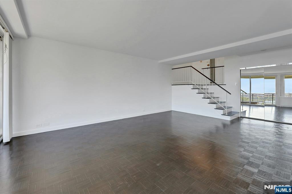 1 Horizon Road, Unit 609 Fort Lee, NJ 07024 - Photo 11 of 40 an empty room with wooden floor and windows