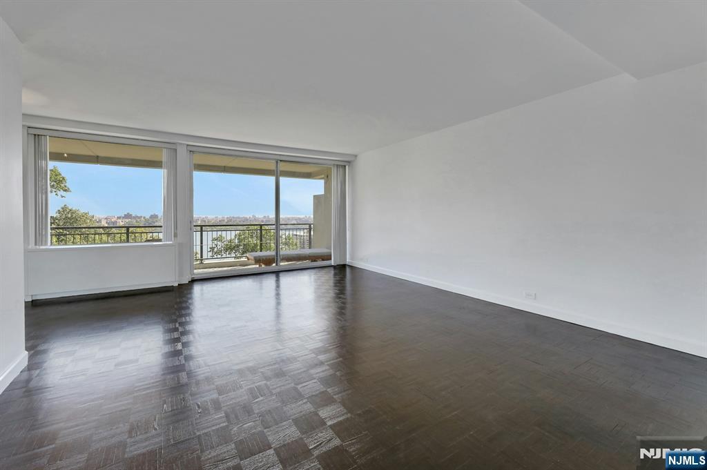 1 Horizon Road, Unit 609 Fort Lee, NJ 07024 - Photo 14 of 40 an empty room with floor to ceiling windows and wooden floor