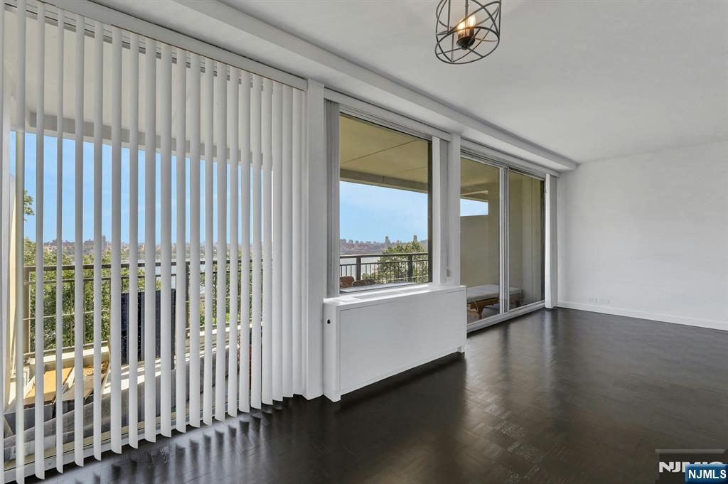 1 Horizon Road, Unit 609 Fort Lee, NJ 07024 - Photo 17 of 40 an empty room with wooden floor and windows