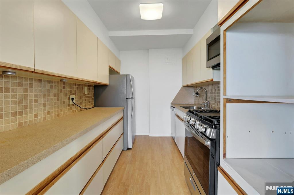 1 Horizon Road, Unit 609 Fort Lee, NJ 07024 - Photo 19 of 40 a view of a kitchen with a stove top oven