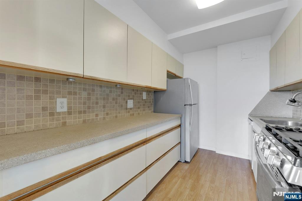 1 Horizon Road, Unit 609 Fort Lee, NJ 07024 - Photo 20 of 40 a view of storage and utility room with washer and dryer