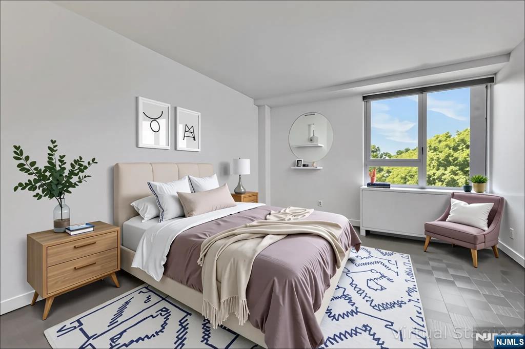 1 Horizon Road, Unit 609 Fort Lee, NJ 07024 - Photo 27 of 40 a bed room with a bed and a couch