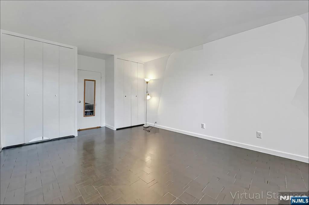 1 Horizon Road, Unit 609 Fort Lee, NJ 07024 - Photo 30 of 40 an empty room with wooden floor and windows