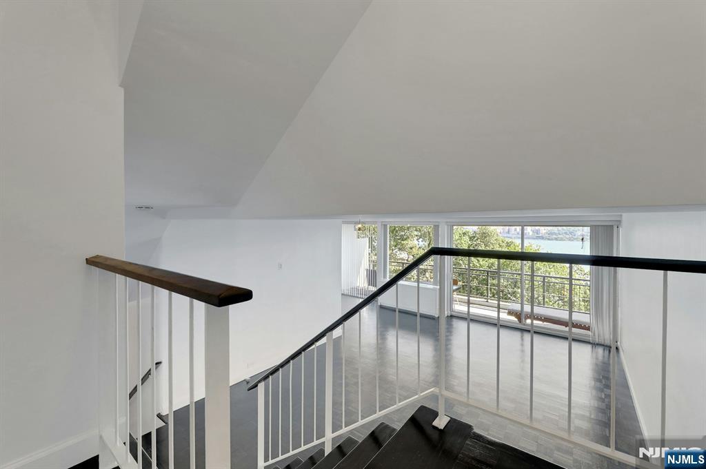 1 Horizon Road, Unit 609 Fort Lee, NJ 07024 - Photo 9 of 40 a view of staircase with railing and white walls