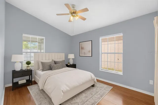 a view of an empty room with a window and a ceiling fan