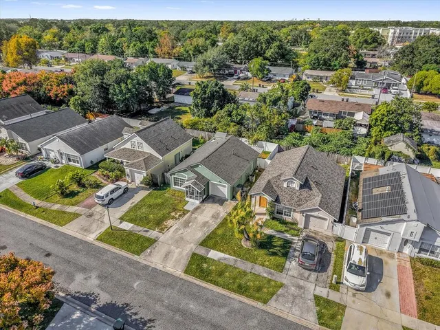 an aerial view of residential houses with outdoor space and swimming pool