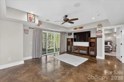 a spacious bedroom with a bed and a large window