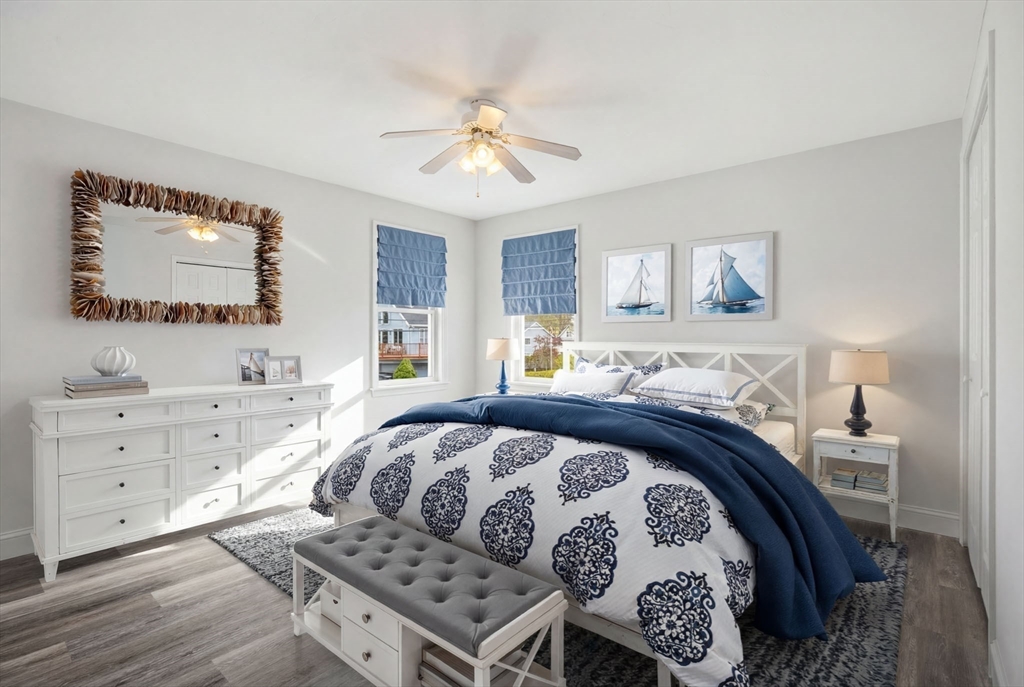 192 Swifts Beach Road Wareham, MA 02571 - Photo 30 of 38 a bedroom with a bed and a chandelier