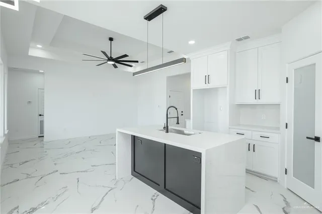 a kitchen with a sink a stove a refrigerator and cabinets