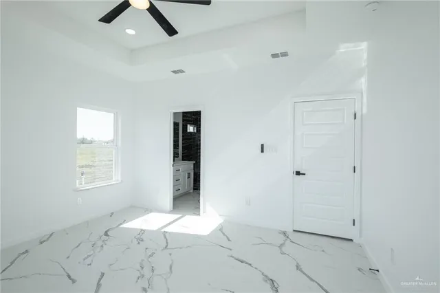 an empty room with windows and closet