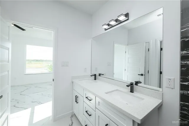 a bathroom with a sink vanity and mirror