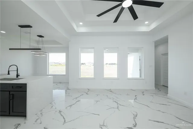 a view of room with a ceiling fan and window