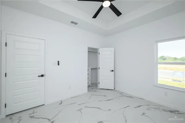 an empty room with closet and windows