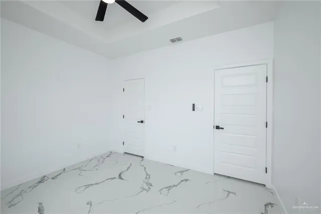 an empty room with a ceiling fan