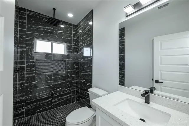 a bathroom with a sink toilet and shower