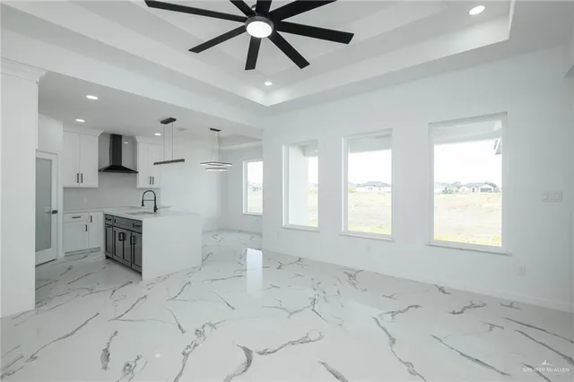 a view of an empty room with a kitchen