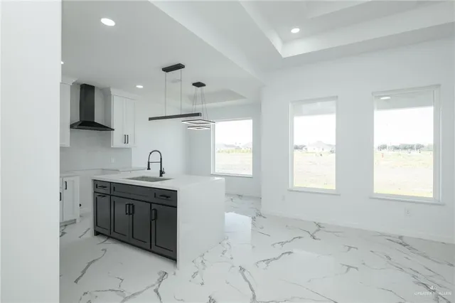 a kitchen with stainless steel appliances granite countertop a sink and a stove