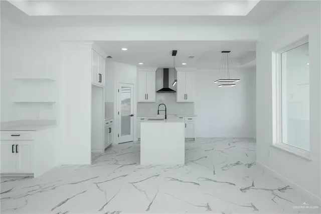 a view of a kitchen with white cabinets