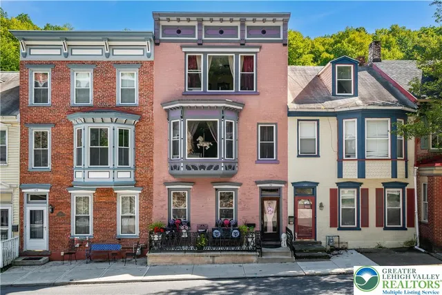 a front view of a residential apartment building with a yard