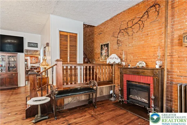 a living room with furniture a chandelier and a dining table