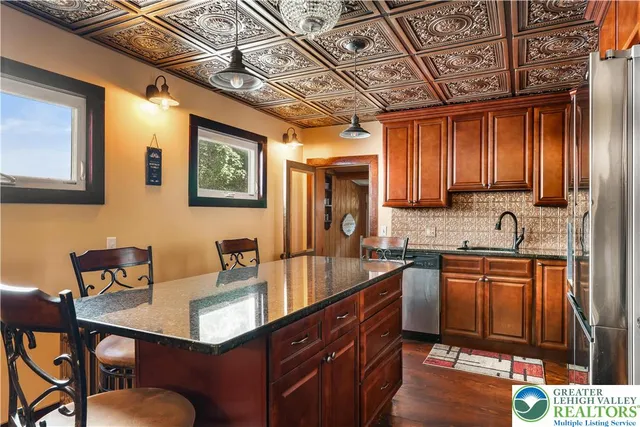 a kitchen with granite countertop a sink and a wooden cabinets