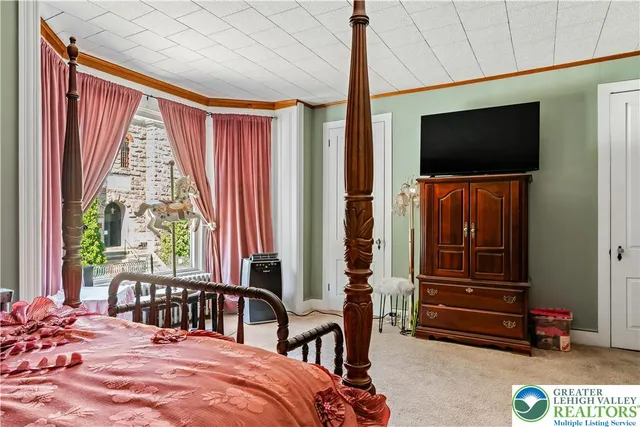 a bedroom with furniture and a window