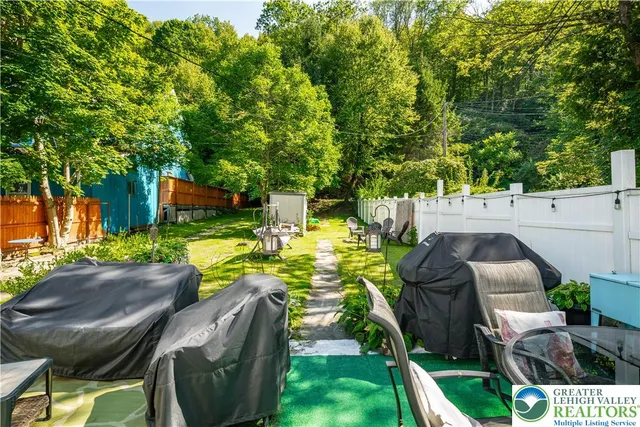 an aerial view of a city with lots of residential buildings ocean and mountain view in back