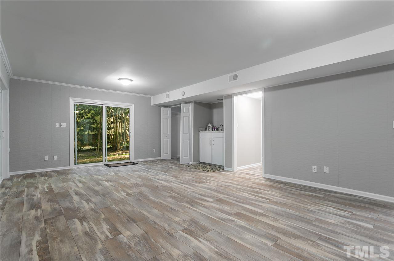4020 Grimstead Lane Raleigh, NC 27613 - Photo 14 of 30 a view of an empty room with wooden floor and a window