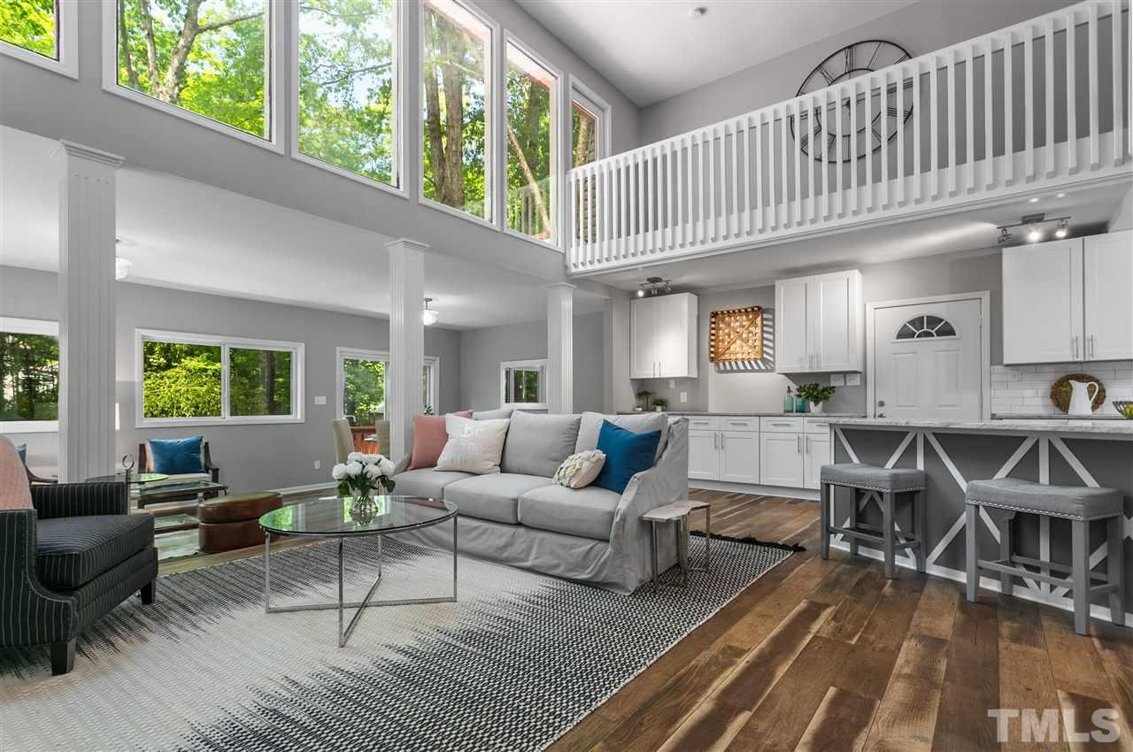 4020 Grimstead Lane Raleigh, NC 27613 - Photo 3 of 30 a living room with furniture wooden floor and a large window