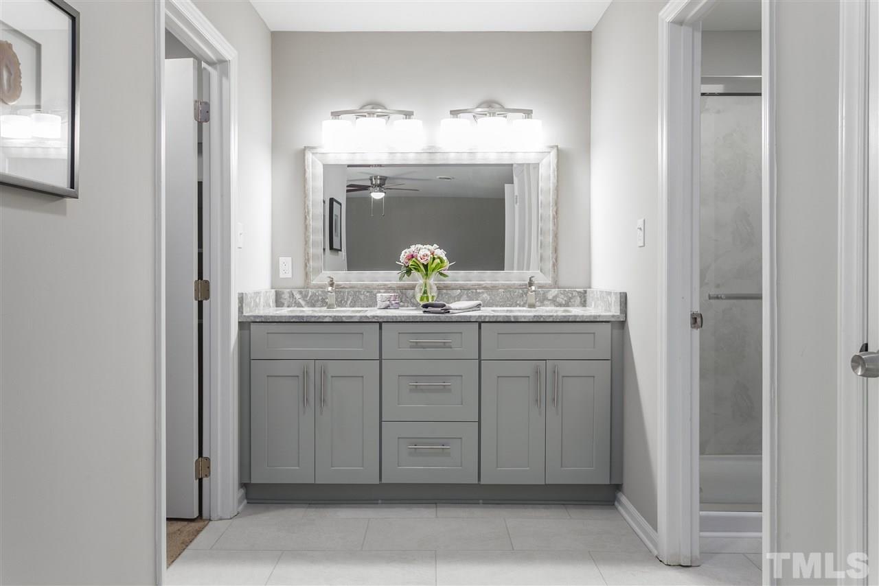 4020 Grimstead Lane Raleigh, NC 27613 - Photo 22 of 30 a bathroom with a double vanity sink and a mirror