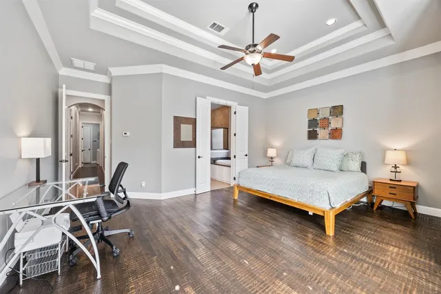 a spacious bedroom with a bed and large windows